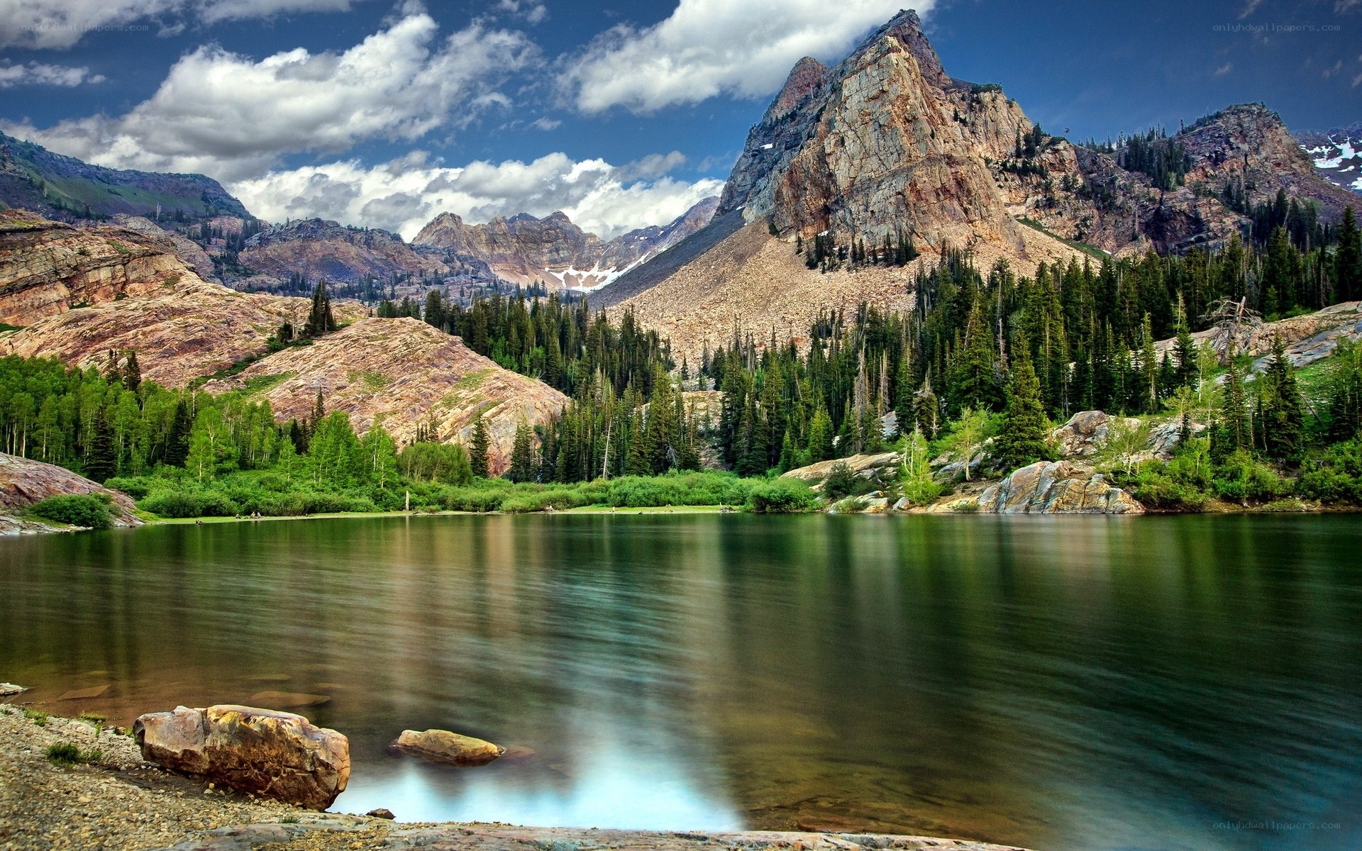 Mountain lake with forest and peaks