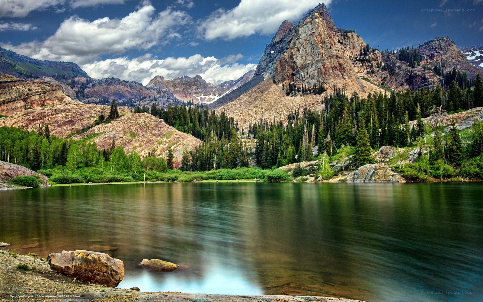 Mountain lake with forest and peaks