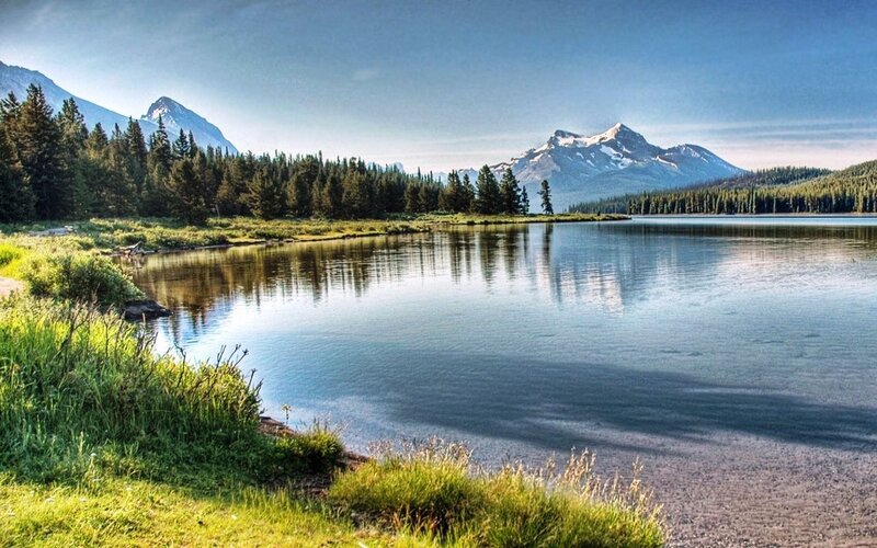 Mountain lake with forest and peaks