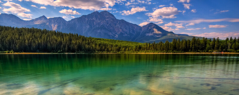 Mountain lake with forest and peaks