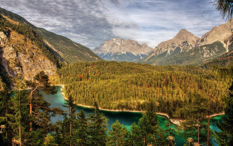 Mountain lake with forest and peaks