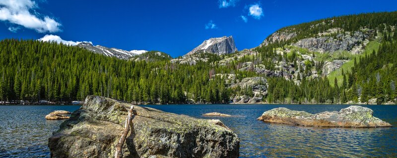 Mountain lake with forest and peaks