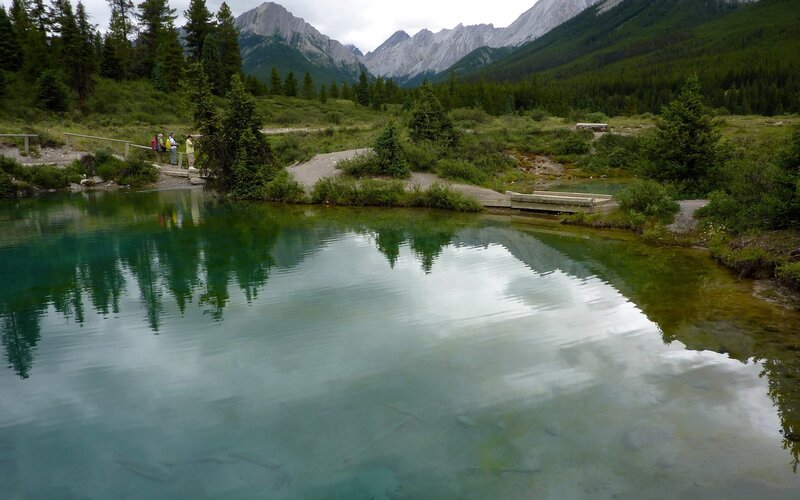 Mountain lake with forest and peaks