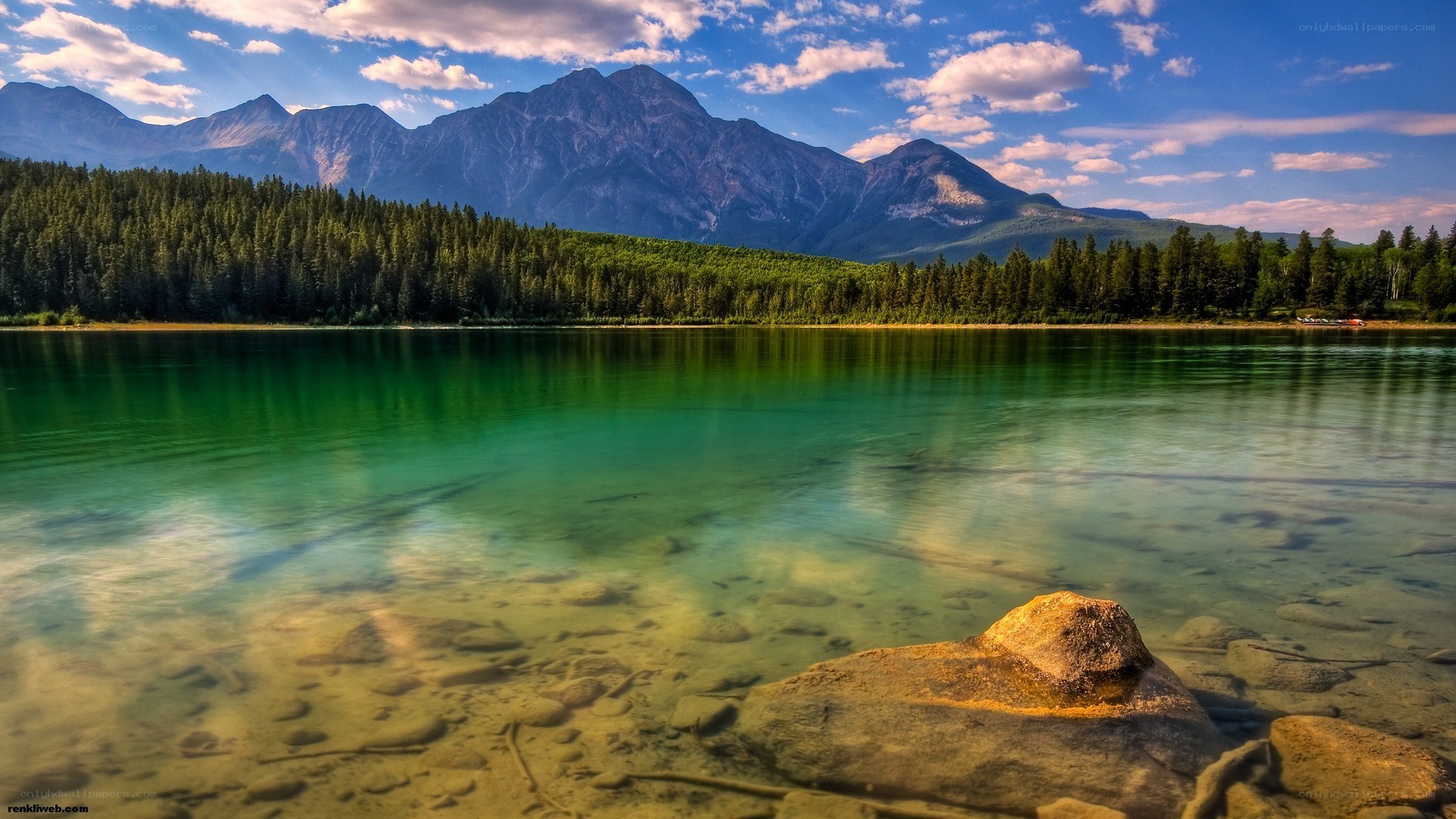 Mountain lake with forest and peaks