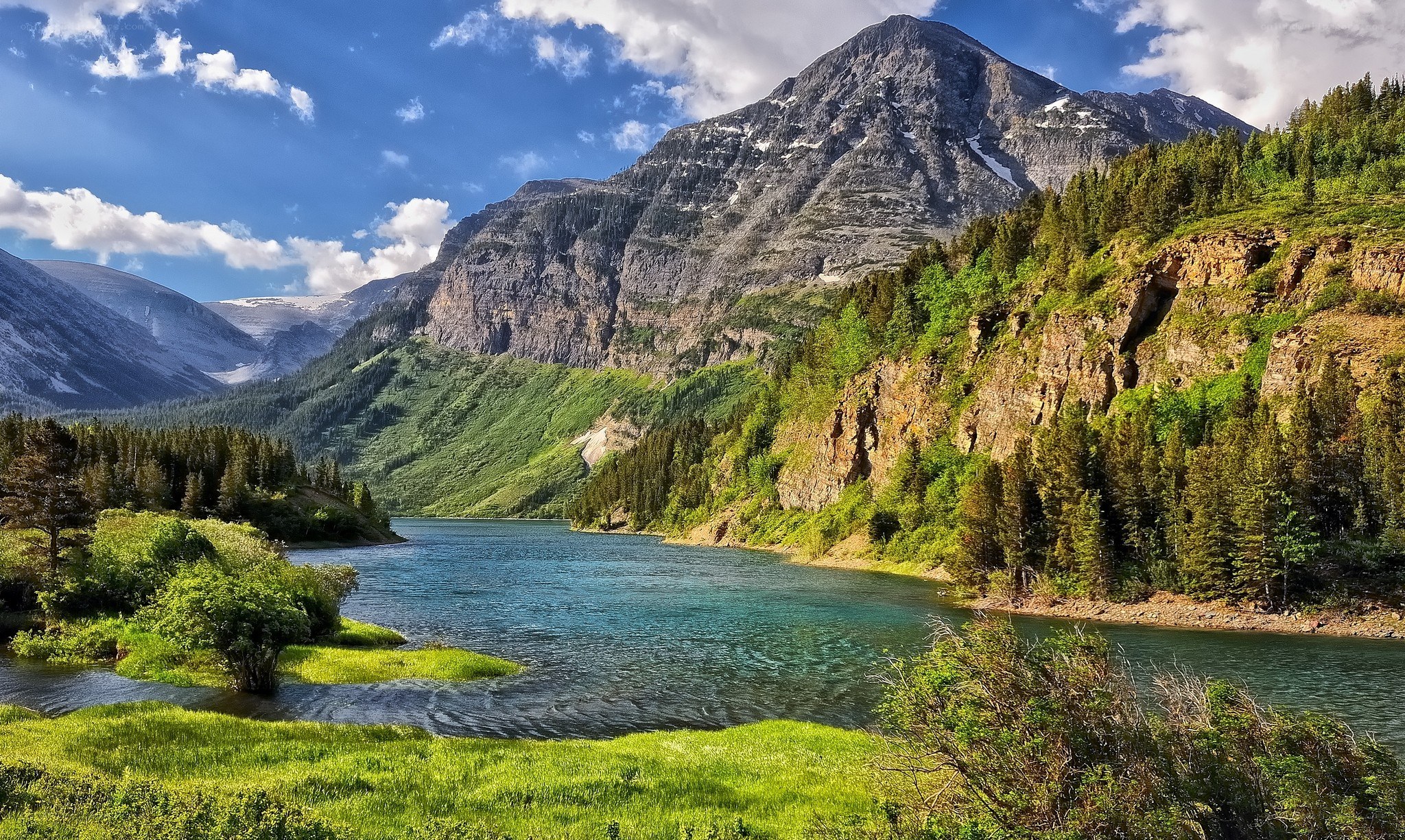 Mountain lake with forest and peaks