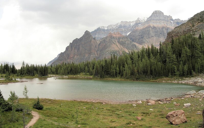 Mountain lake with forest and peaks