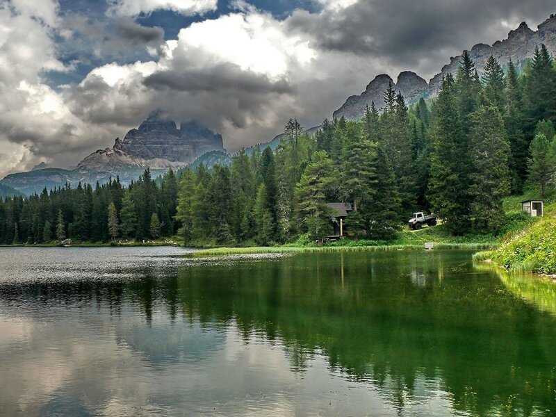 Mountain lake with forest and peaks
