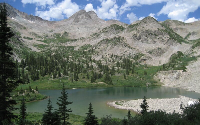 Mountain lake with forest and peaks