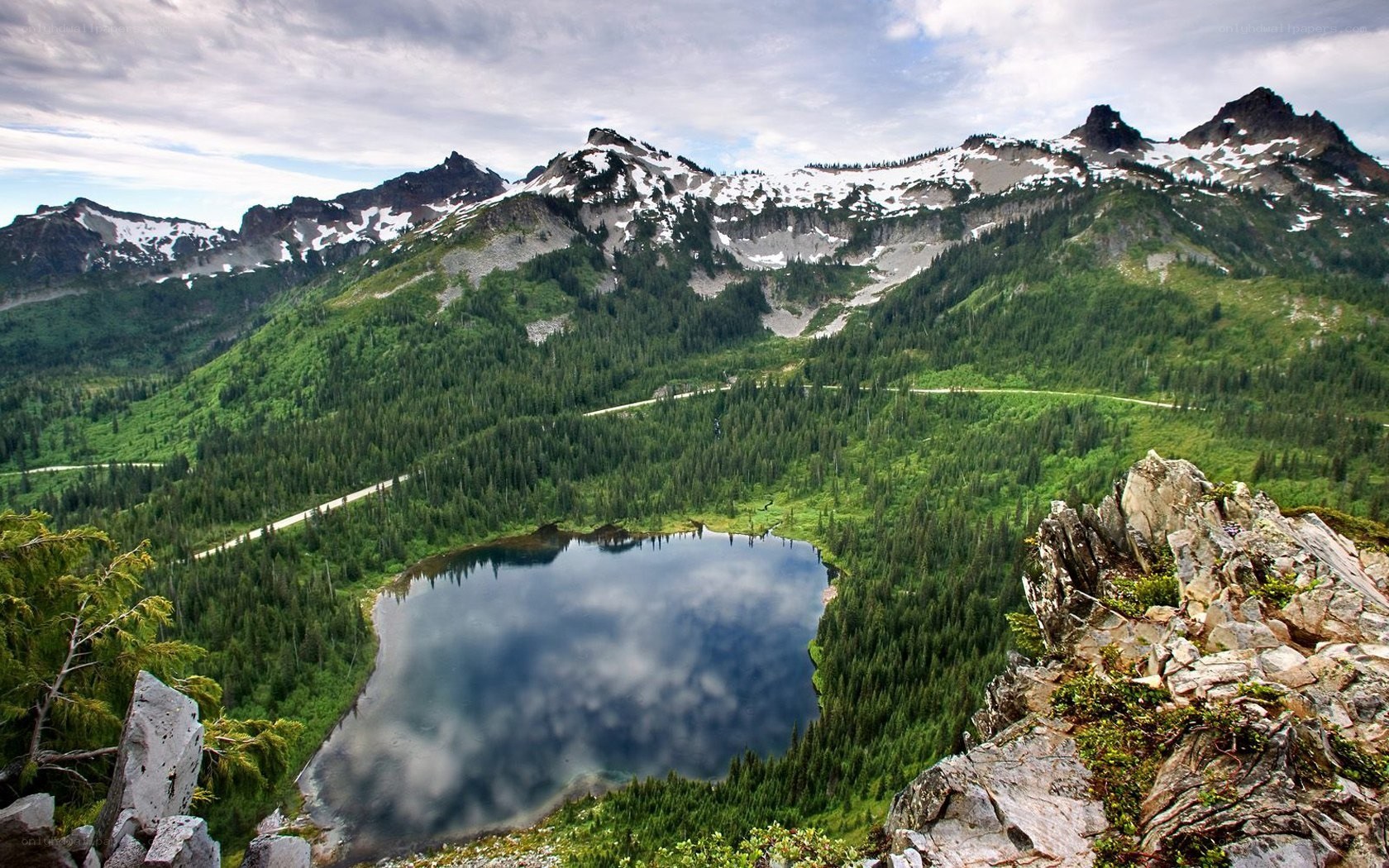 mountain lake with forest and snow