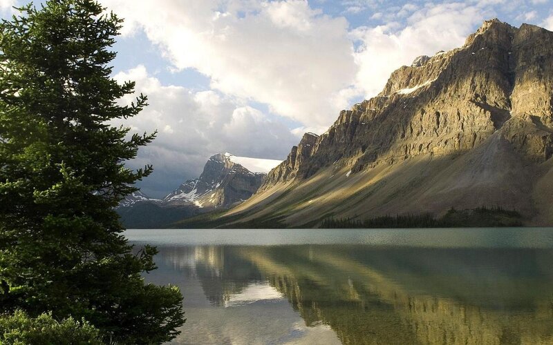 Mountain lake with forest and snow