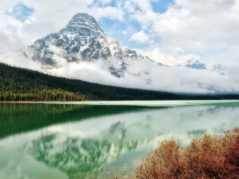 Mountain lake with forest reflection