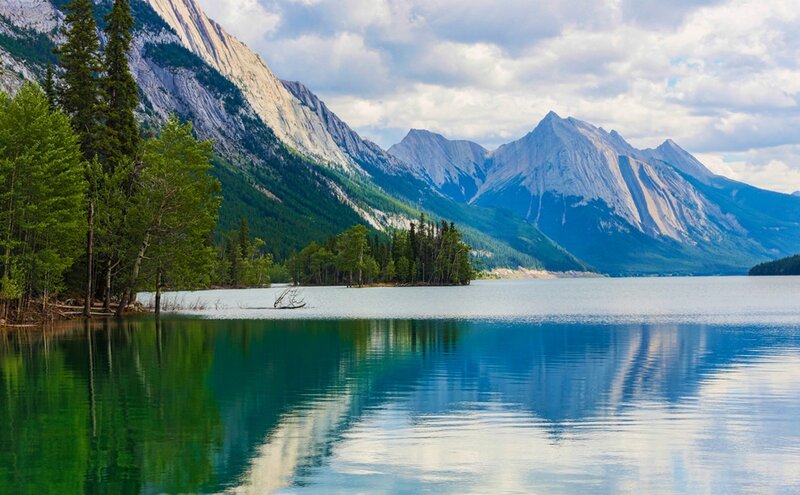 Mountain lake with forest reflection