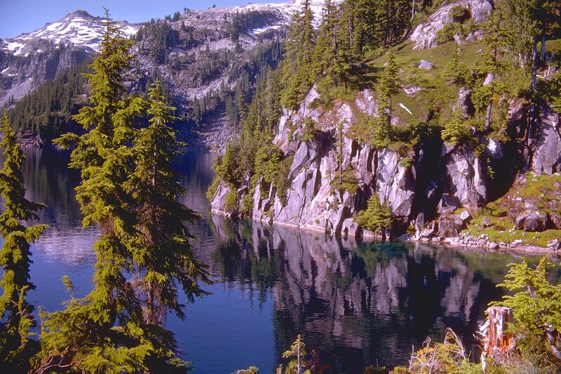 Mountain lake with forested cliffs