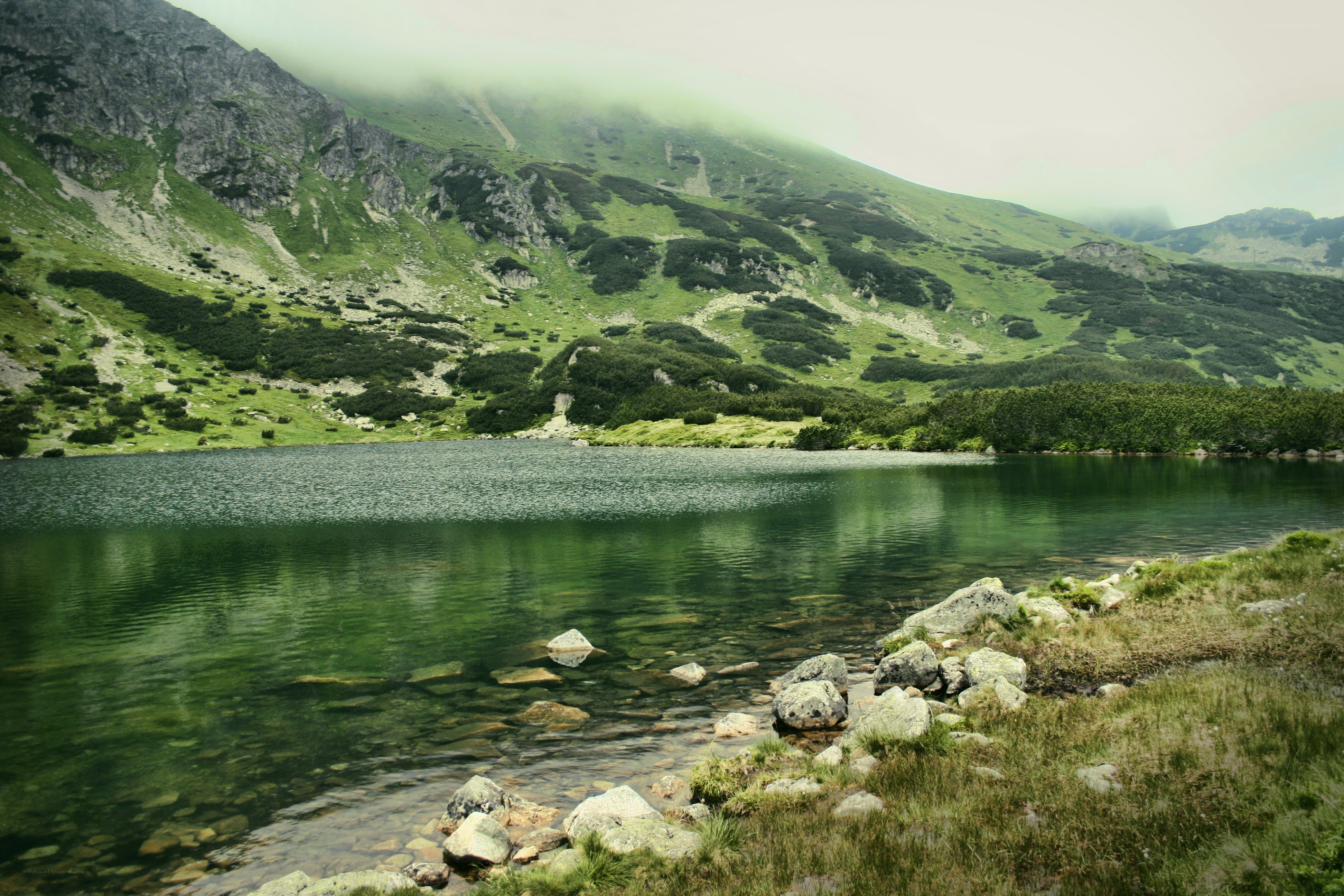 Mountain lake with green hills