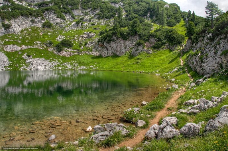 Mountain lake with green reflections