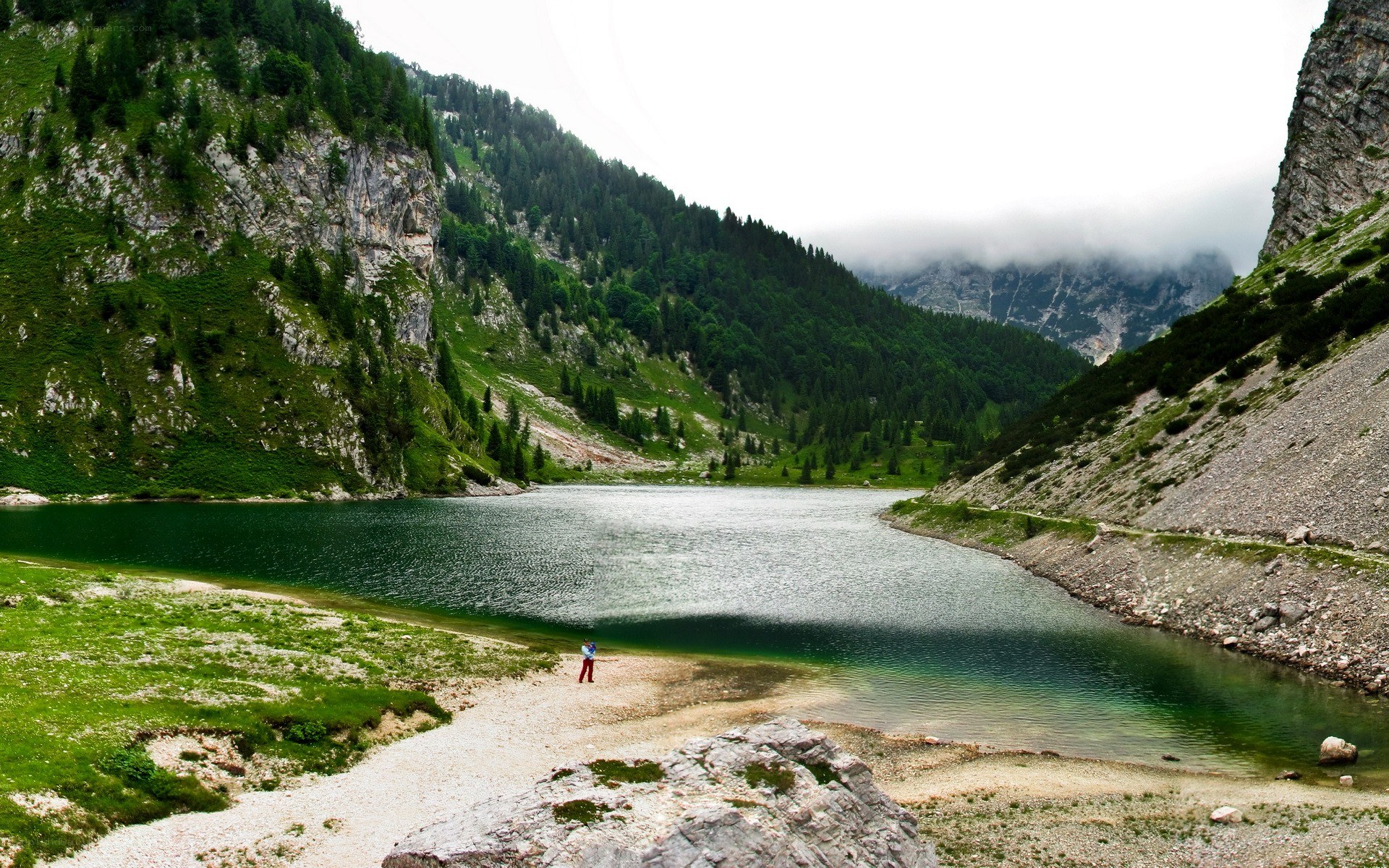 Mountain lake with hiker