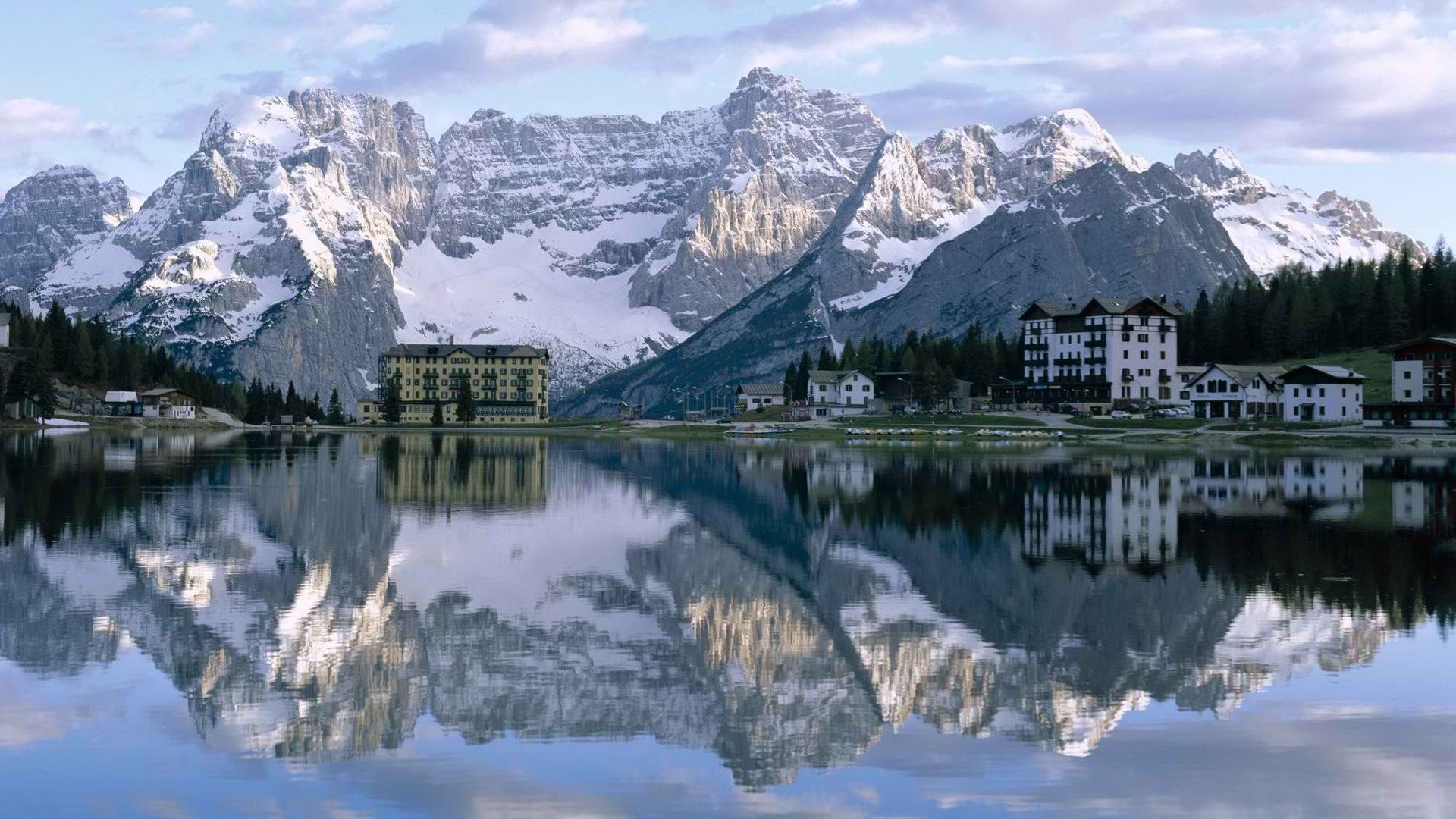 Mountain lake with hotel reflection