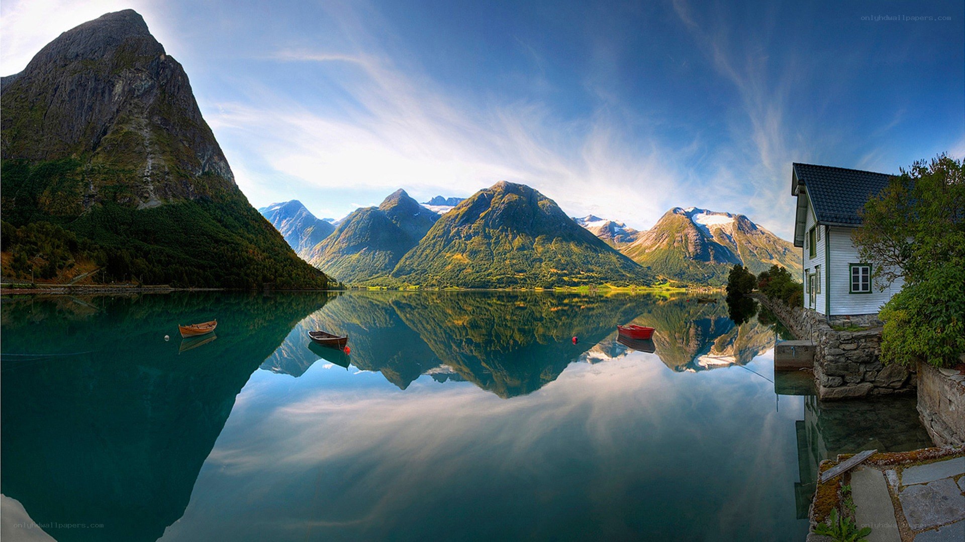 Mountain lake with house reflection