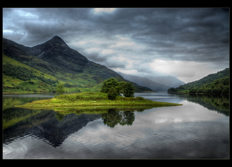Mountain lake with island reflection