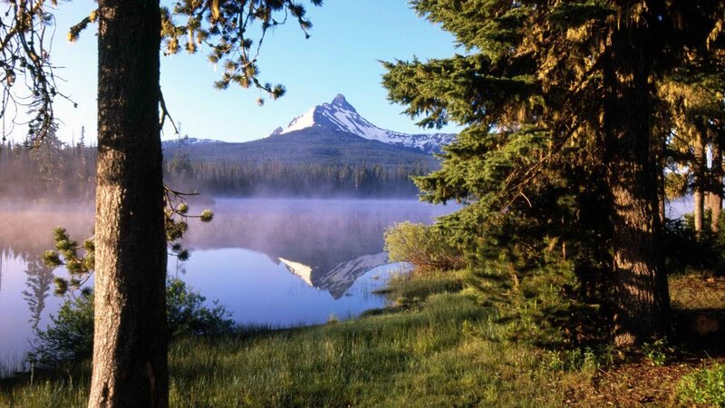 Mountain lake with misty reflection