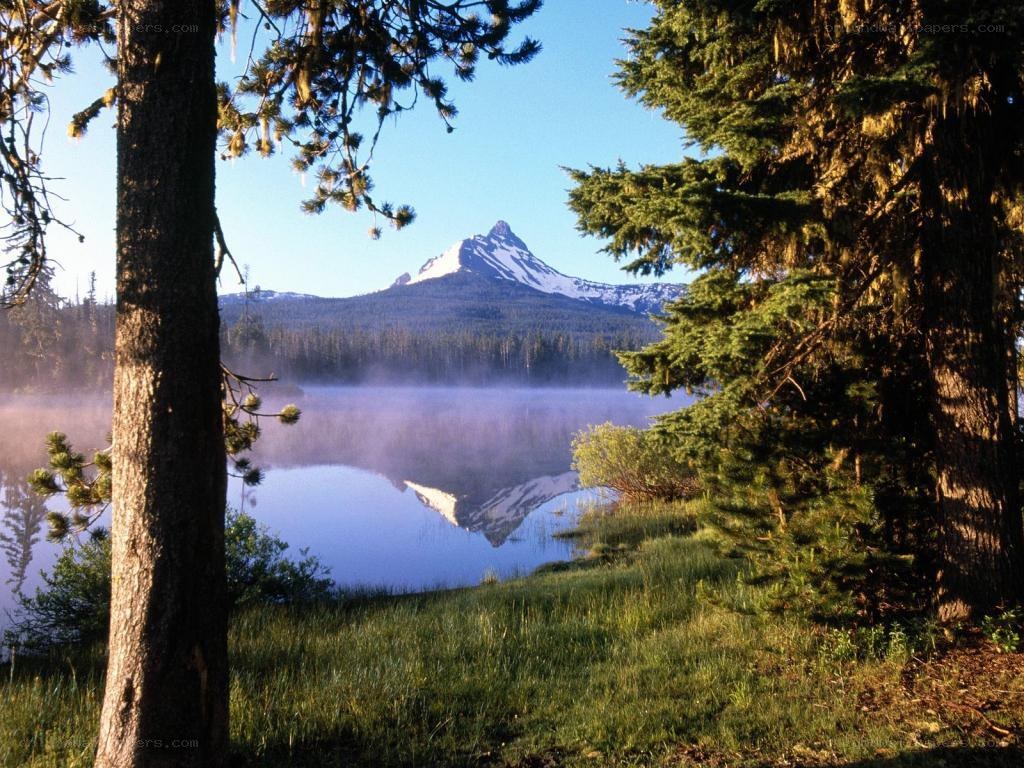 Mountain lake with misty reflection