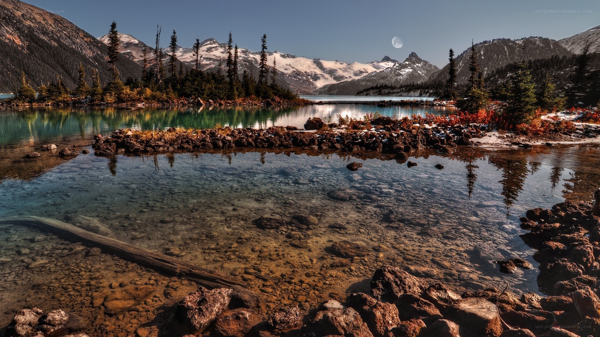 Mountain lake with moon and snow