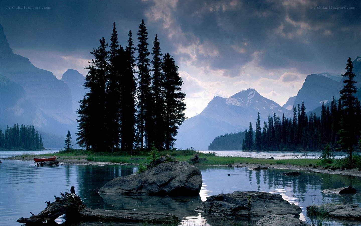 Mountain lake with red canoe