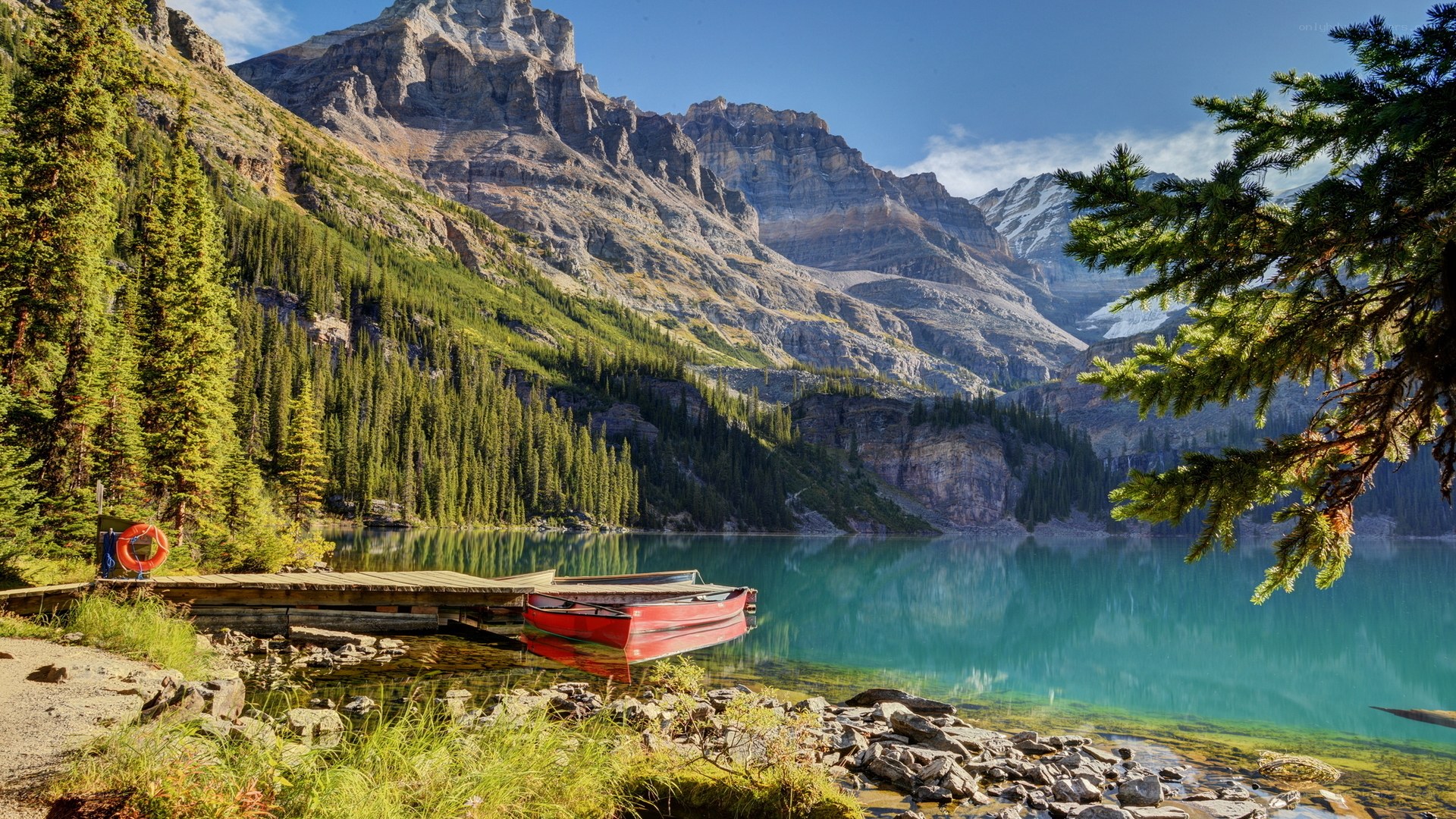 Mountain lake with red canoe