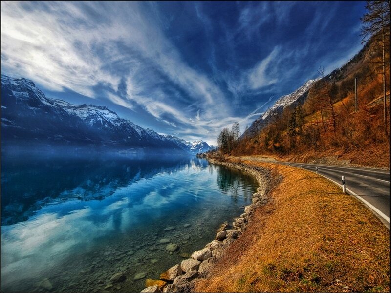 Mountain lake with road and autumn trees