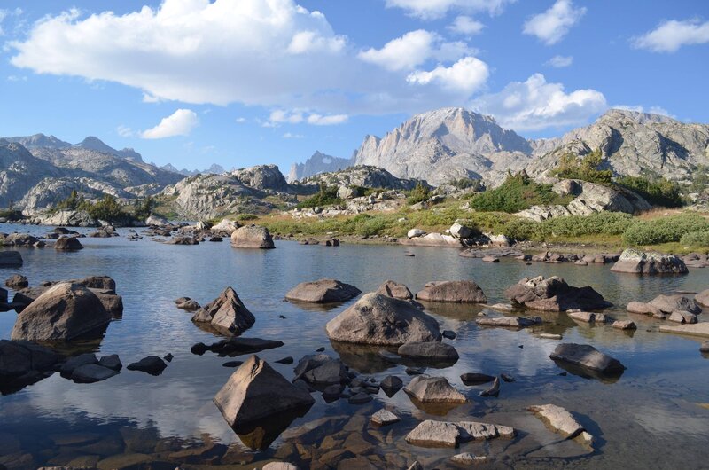 Mountain Lake with Rocks — Blue, Serene, Afternoon, Photograph, Mountains, Sky, Trees