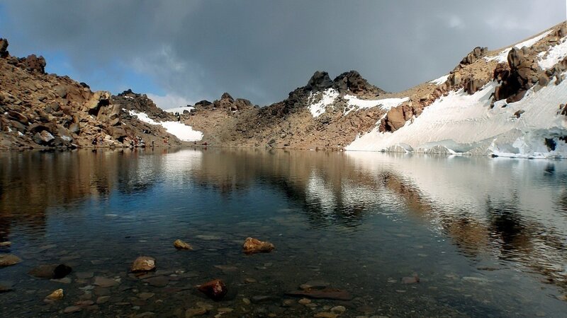 Mountain Lake with Snow — Blue, Dramatic, Afternoon, Photograph, Rocks, People