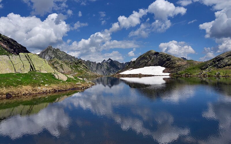Mountain lake with snow patch