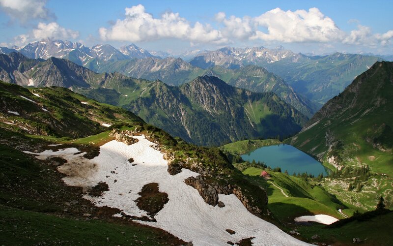 Mountain lake with snow patches