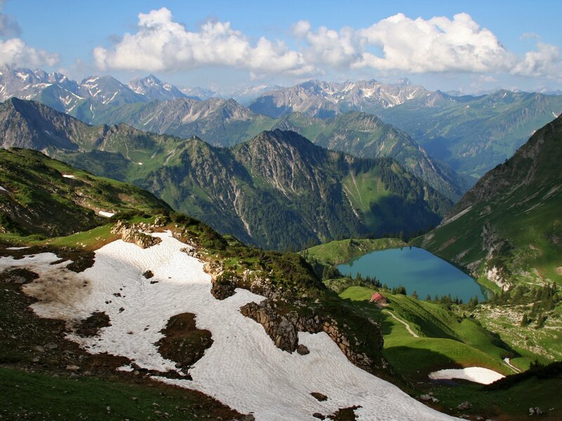 Mountain lake with snow patches
