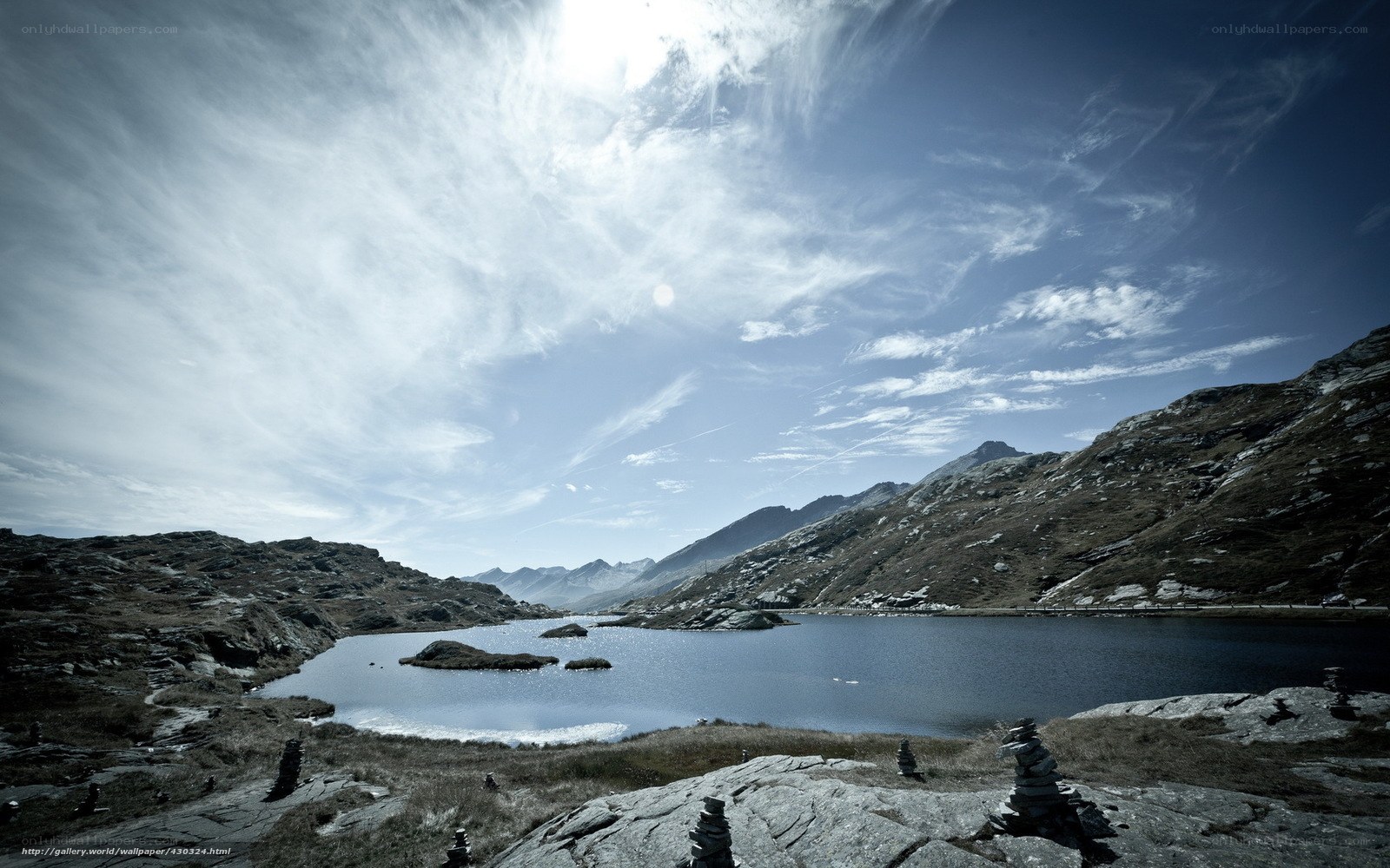 Mountain lake with stone cairns