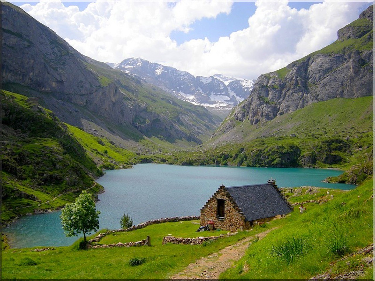 Mountain lake with stone hut