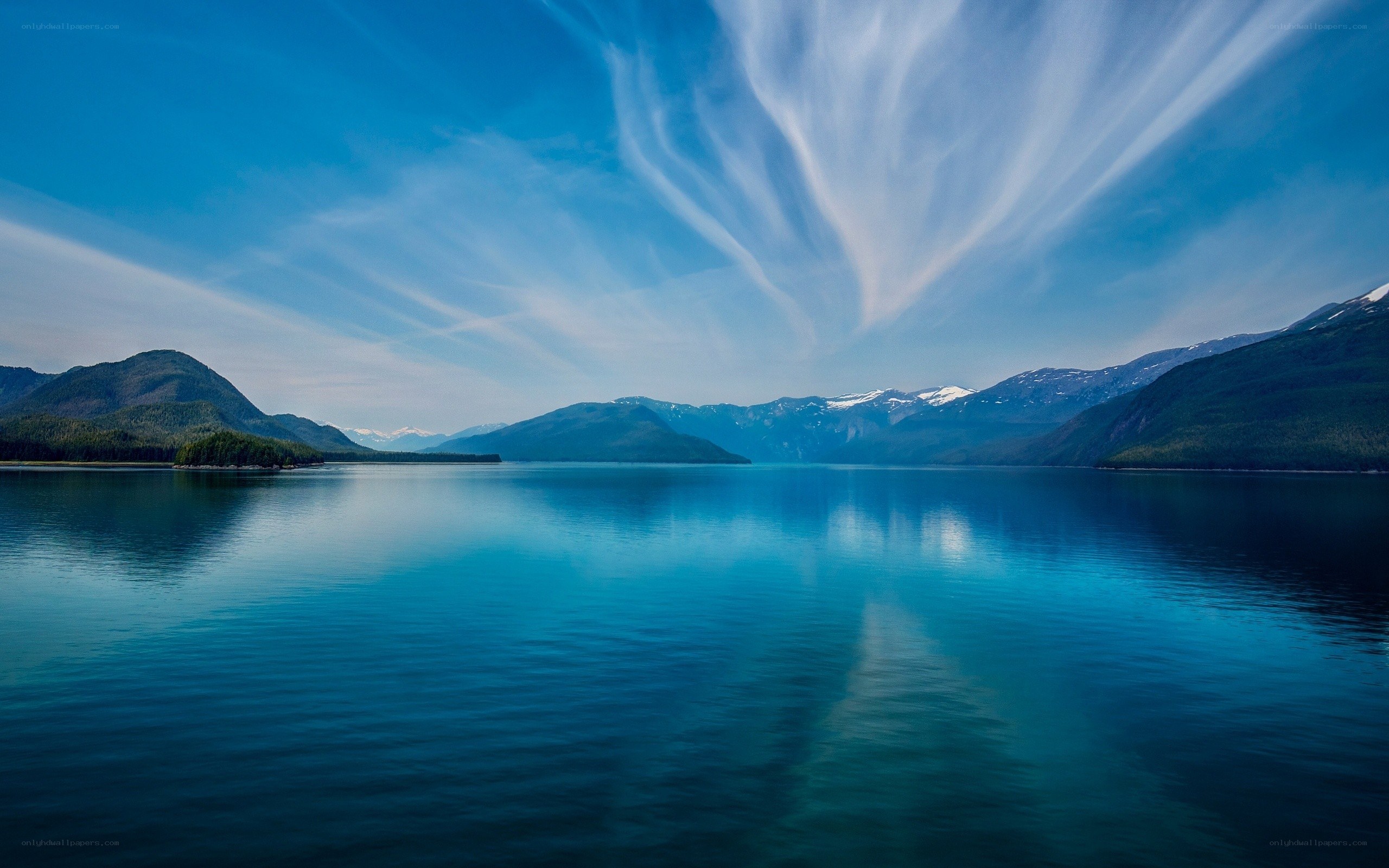 Mountain lake with wispy clouds