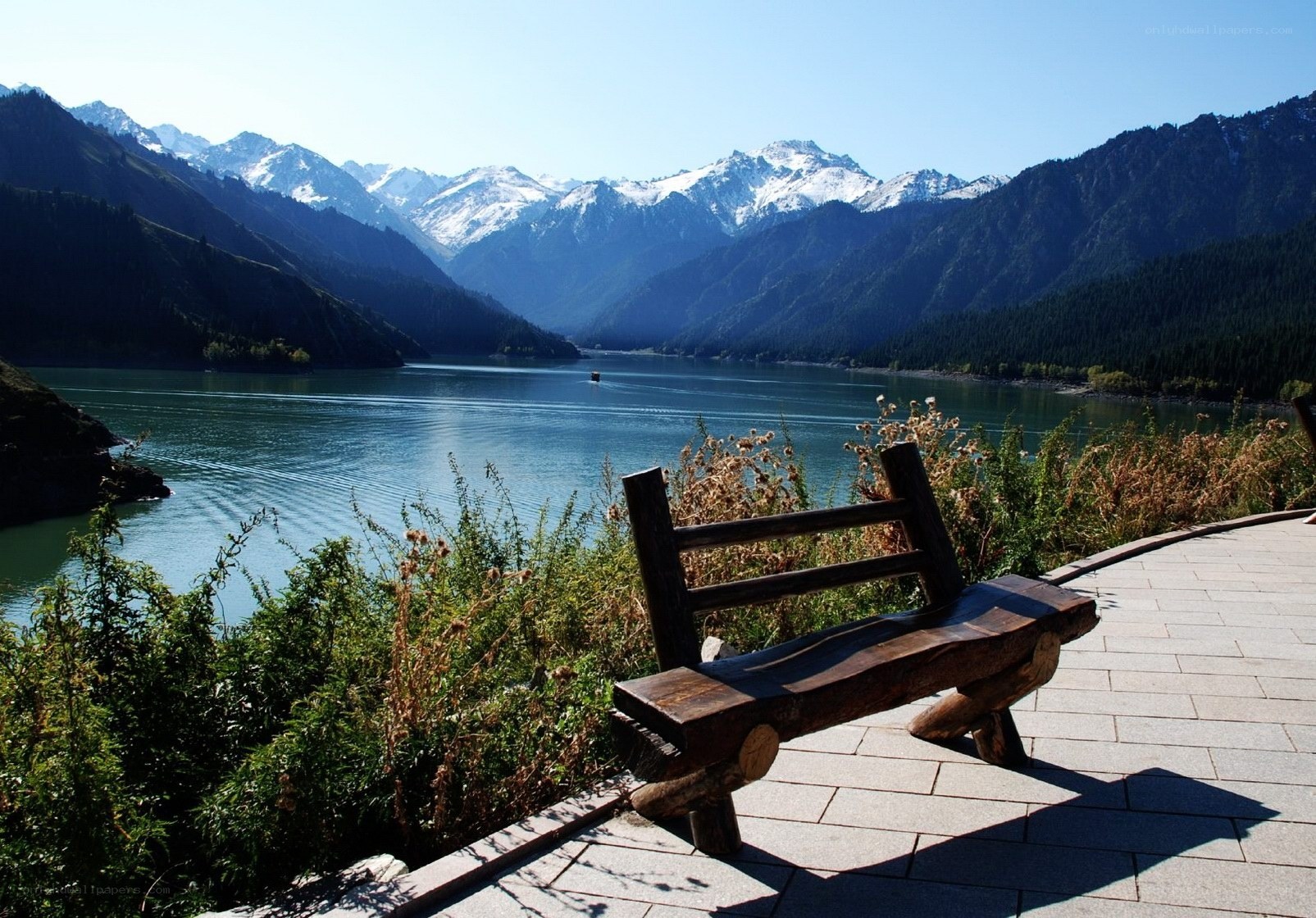 Mountain lake with wooden bench
