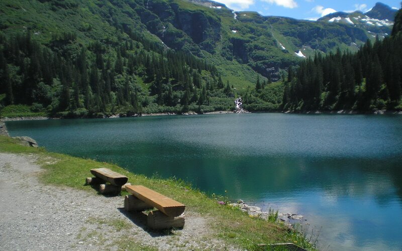 Mountain lake with wooden benches
