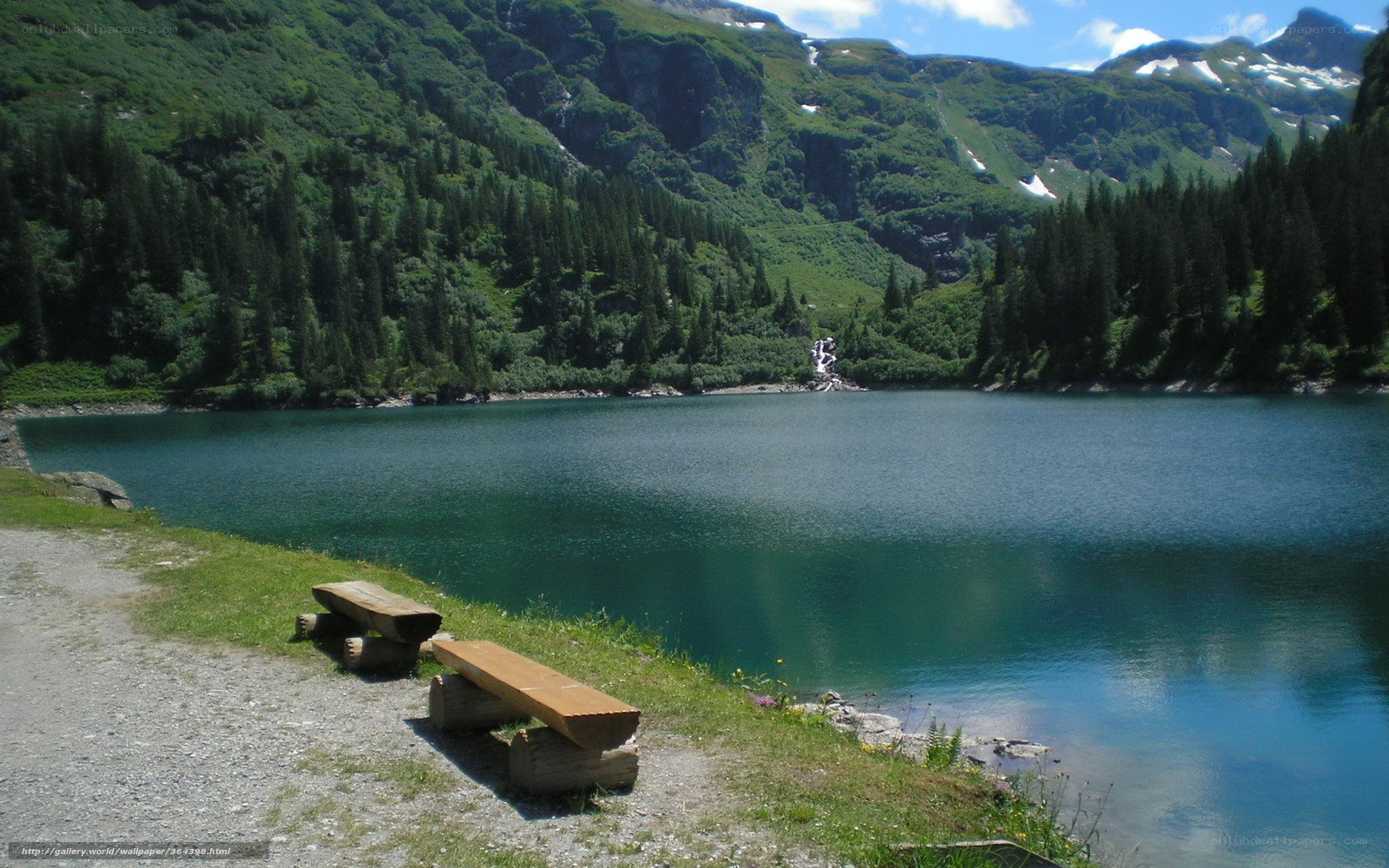 Mountain lake with wooden benches