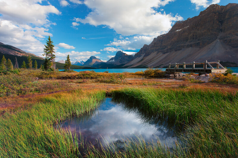 Mountain lake with wooden bridge