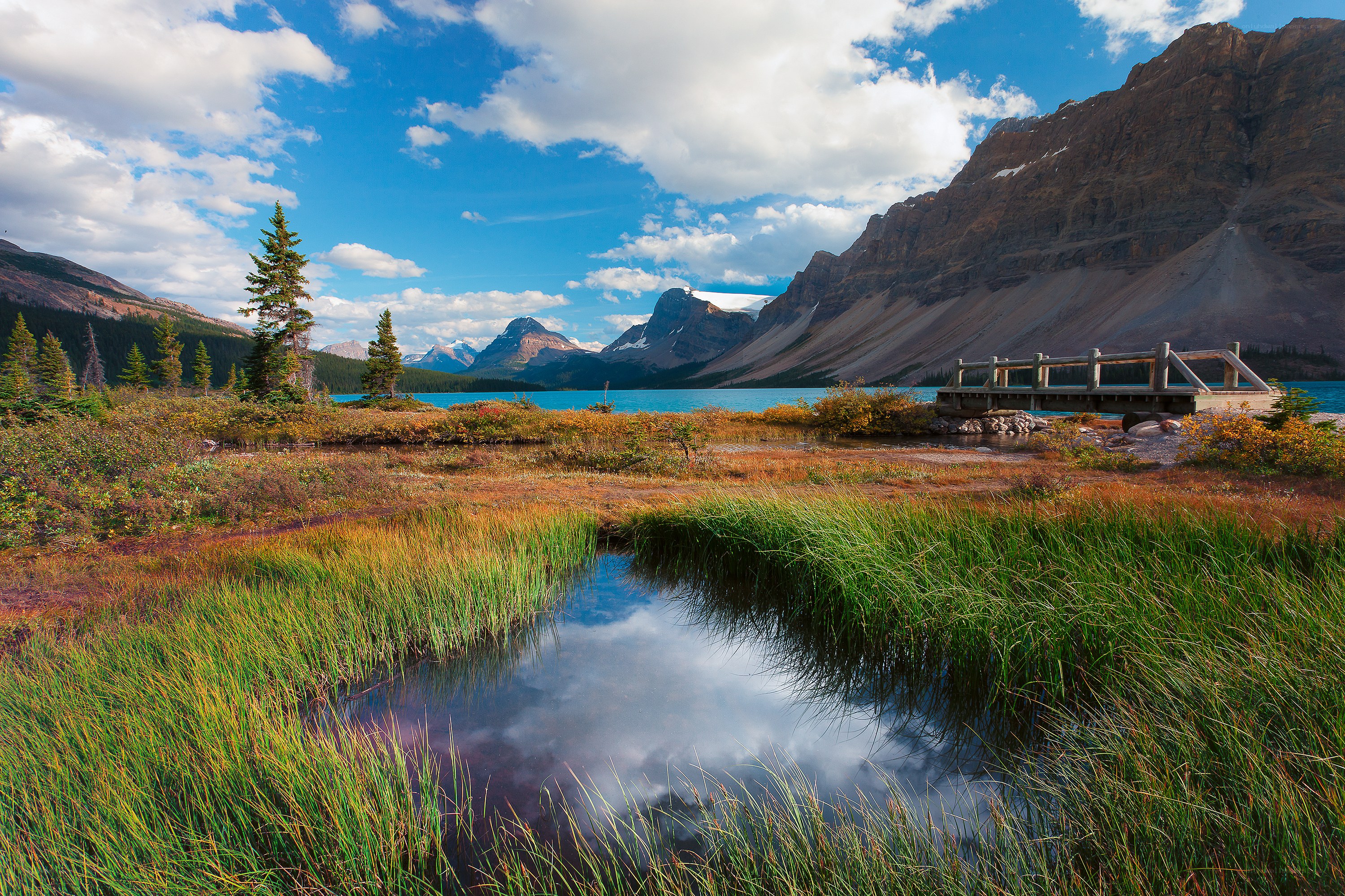 Mountain lake with wooden bridge