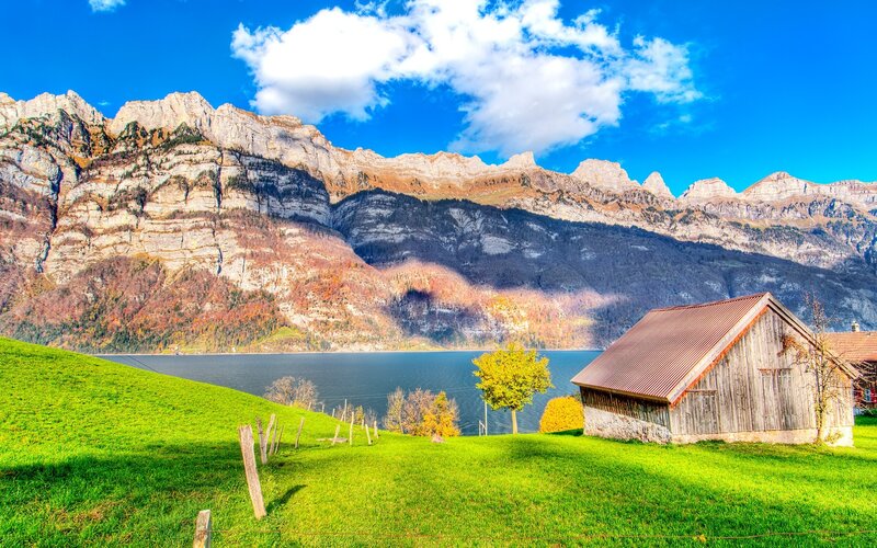 Mountain lake with wooden cabin