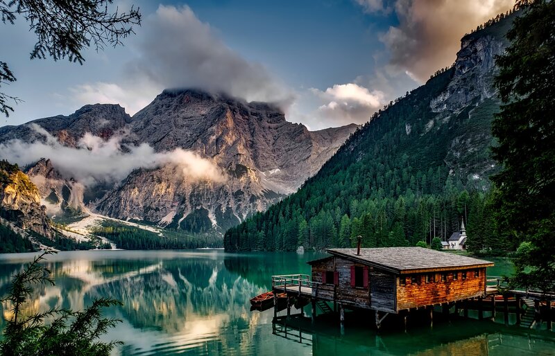 Mountain lake with wooden cabin