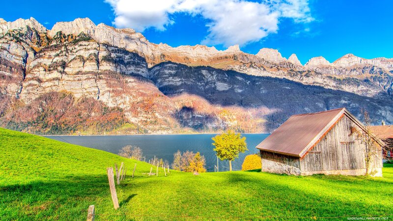 Mountain lake with wooden cabin