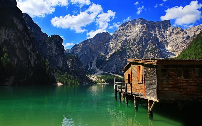 Mountain lake with wooden cabin