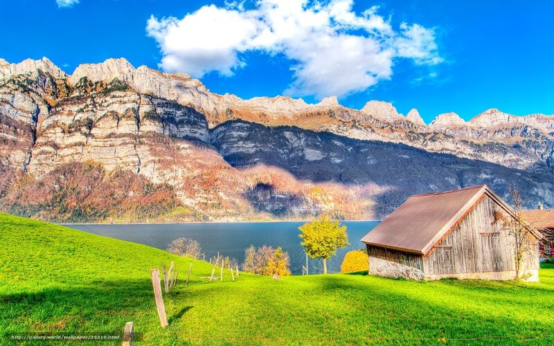 Mountain lake with wooden cabin