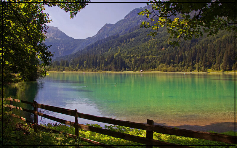 Mountain lake with wooden fence