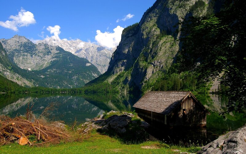 Mountain lake with wooden hut