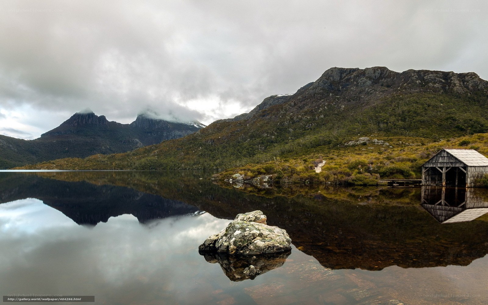 Mountain lake with wooden hut